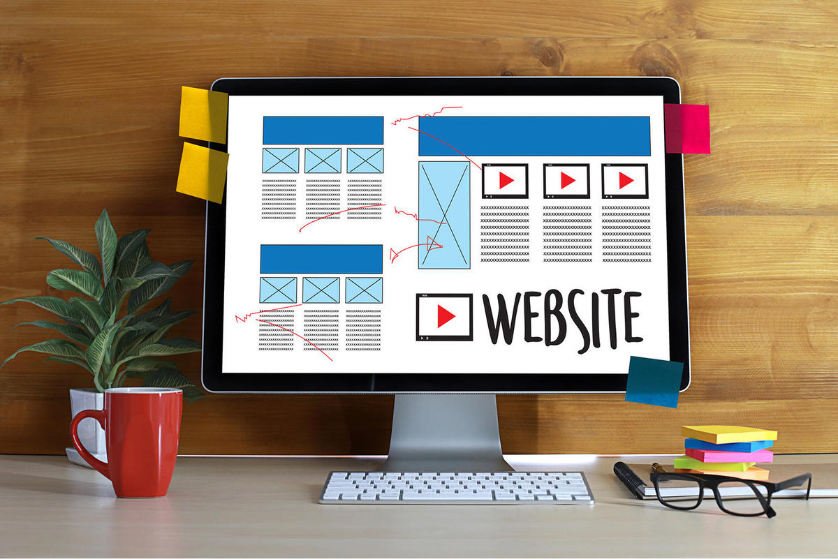 Website layouts being planned on a desktop screen
